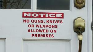 A sign at Clay City Hall prohibits guns, knives or weapons on premises. Photo by Scott Buttram