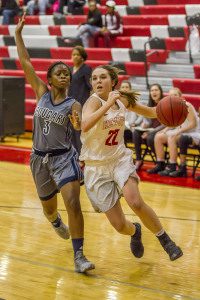 Hewitt-Trussville's Bailey Berry drives to the basket with Clay-Chalkville's Erica Lockahrt defending. Photo by Ron Burkett.