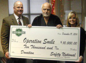 Alabama Retail Comp Fund Manager Mark Young, left, and Business Process Manager Tessa Lowery, right, present the check for Operation Smile to Dr. Zenko Hrynkiw on behalf of Safety National. submitted photo