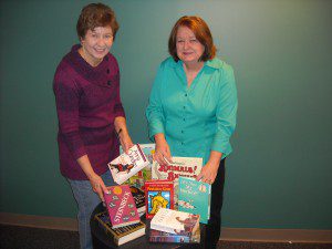 Joyce Ogletree, left, and Beverly Guerdat display several books from hundreds that will be on sale March 12-15 in the meeting room at the Trussville Public Library. submitted photo