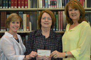 Trussville Public Library Director Emily Tish, center, receiving the check submitted photo
