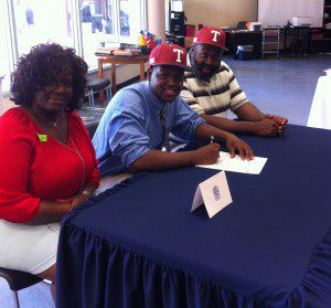 Brandon Wood with his parents at his signing ceremony photo by Erik Harris