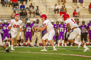 Hewitt-Trussville QB Zac Thomas takes a snap this spring against Minor. photo by Ron Burkett