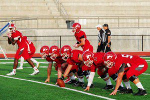Hewitt-Trussville's offensive front takes snaps prior to the 2015 season opener. photo by Kristi Slawson