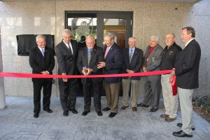 Director Howard Summerford cuts the ribbon at the new E-911 Consolidated Communications Center in Center Point.  Photo by Chris Yow