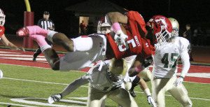 Hewitt-Trussville running back Jarrion Street goes airborne in 2015. Photo by Chris Yow