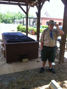 Ben Isom stands at the barbecue pit at Holy Infant of Prague Catholic Church, where he recently finished his Eagle Scout project by building a brick paver walkway. Submitted photo
