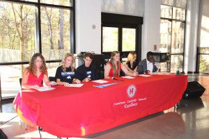 From left to right: Hewitt-Trussville athletes LeAnn Guess, Marlee Mason, Ben Knox, Bailey Murphy, Maddie Dorsett and Tyler Tolbert signing national letters of intent last week at HTHS. Photo by Erik Harris 