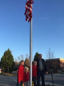 Complete Cleaners Founder John Patterson with his grandsons Noah, Cade and Pate Williams at the new flag pole.