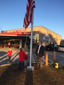 Noah, Cade and Pate Williams raise the flag up the new pole at Complete Cleaners  on Pearl Harbor Day. Submitted photo
