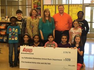 On Monday, Logan’s Roadhouse presented students and staff at Fultondale Elementary a check for $539 to be used in the school’s music program.  (submitted photo)