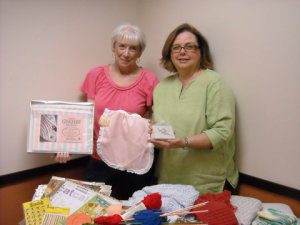 Susan Branch (left) and Trudy Strain (right) display a few of the items to be sold May 14 at a craft sale at the Trussville Library.  Both are members of Friends of the Library, which is sponsoring the event. 
