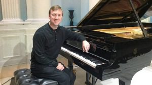 Kevin Grigsby seated at a piano at Alabama Piano Gallery in Vestavia Hills. The Alabama Power market specialist has been chosen to compete in the Cliburn International Amateur Piano Competition. (JPhoto courtesy of McClaran) 