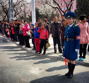 Onlookers line the streets to cheer on marathon and half marathon runners in Pyongyang. 
