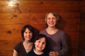 Diana and Jessie Harmon are pictured with their younger sister, Amber. Photo via GoFundMe.com