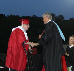 Collin LaFon ditched his wheelchair to walk across the stage and accept his diploma. Photo by Ron Burkett/The Trussville Tribune