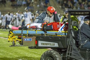 Chris Horn checks on his son, Hewitt-Trussville's Peyton Horn, who suffered a concussion in Friday night's game.  Photo by Ron Burkett/The Trussville Tribune