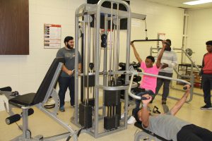 Omar Zampoalteca (far left), Romeo Bryant (sitting) and Kevin Strickland (lying down) work out on the equipment used for physical training. Photo by Chris Yow