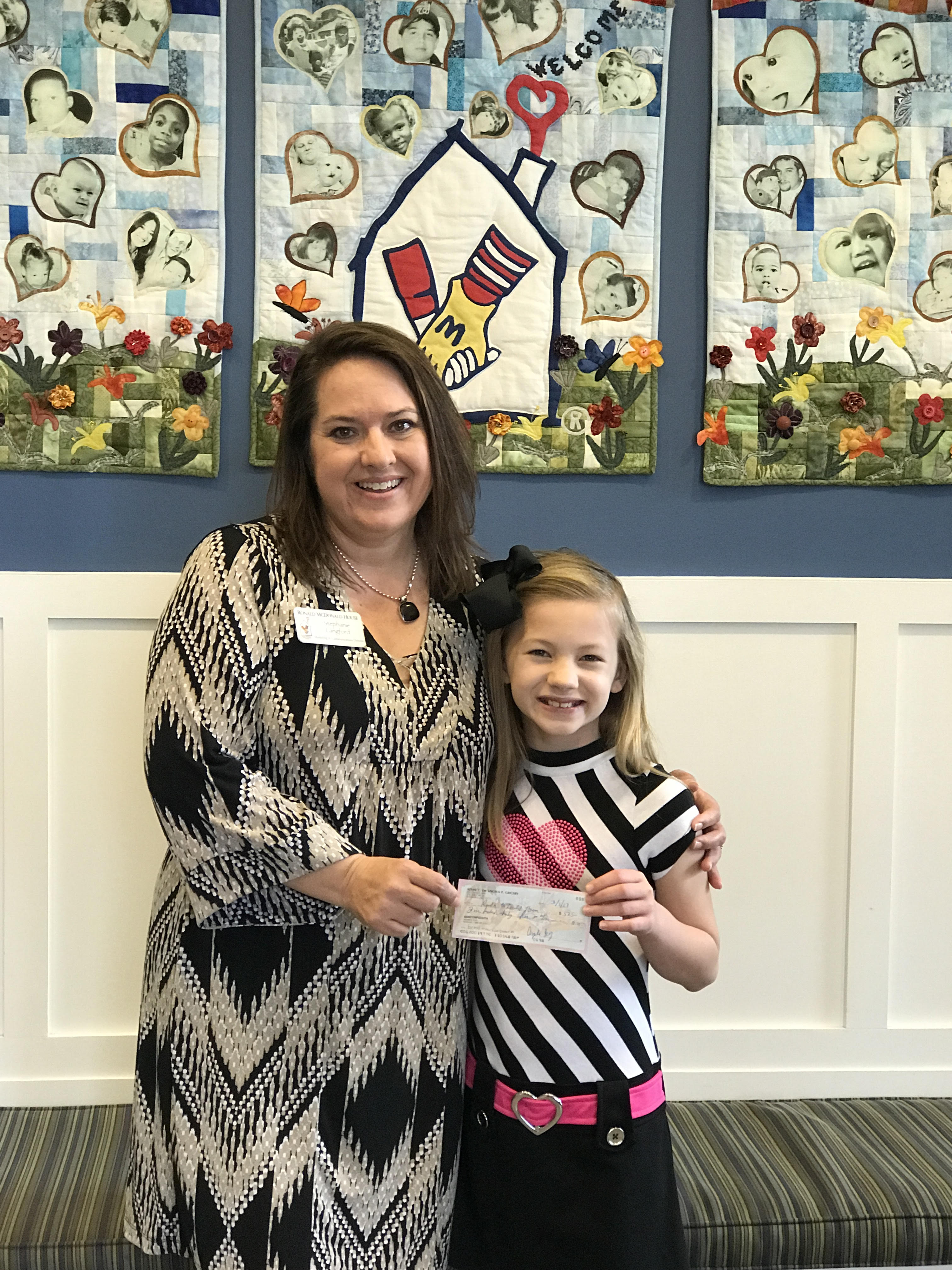 Paine student presents consignment sale check to Ronald McDonald House